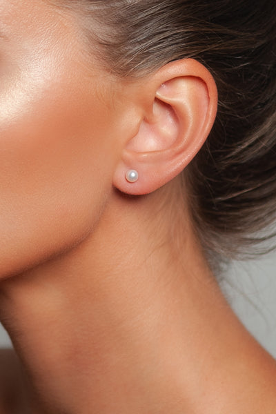 Tiny Pearl Earrings by Peregrina Pearls on a Model