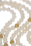 Serious Polka Dot Pearl Necklace - a three-row white fresh-water pearls necklace, a close-up of specially textured golden beads