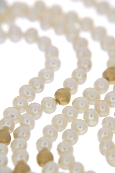 Serious Polka Dot Pearl Necklace - a three-row white fresh-water pearls necklace, a close-up of specially textured golden beads
