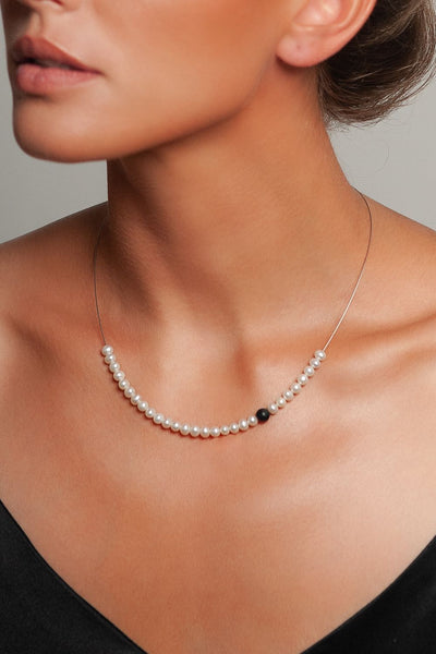 Abacus Pearl Necklace with an Onyx Bead by Peregrina Pearls on a Model